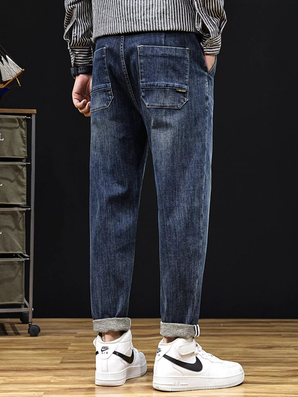 Omina relaxed fit dark wash denim trousers with utility pockets and drawstring waist, cuffed hem.