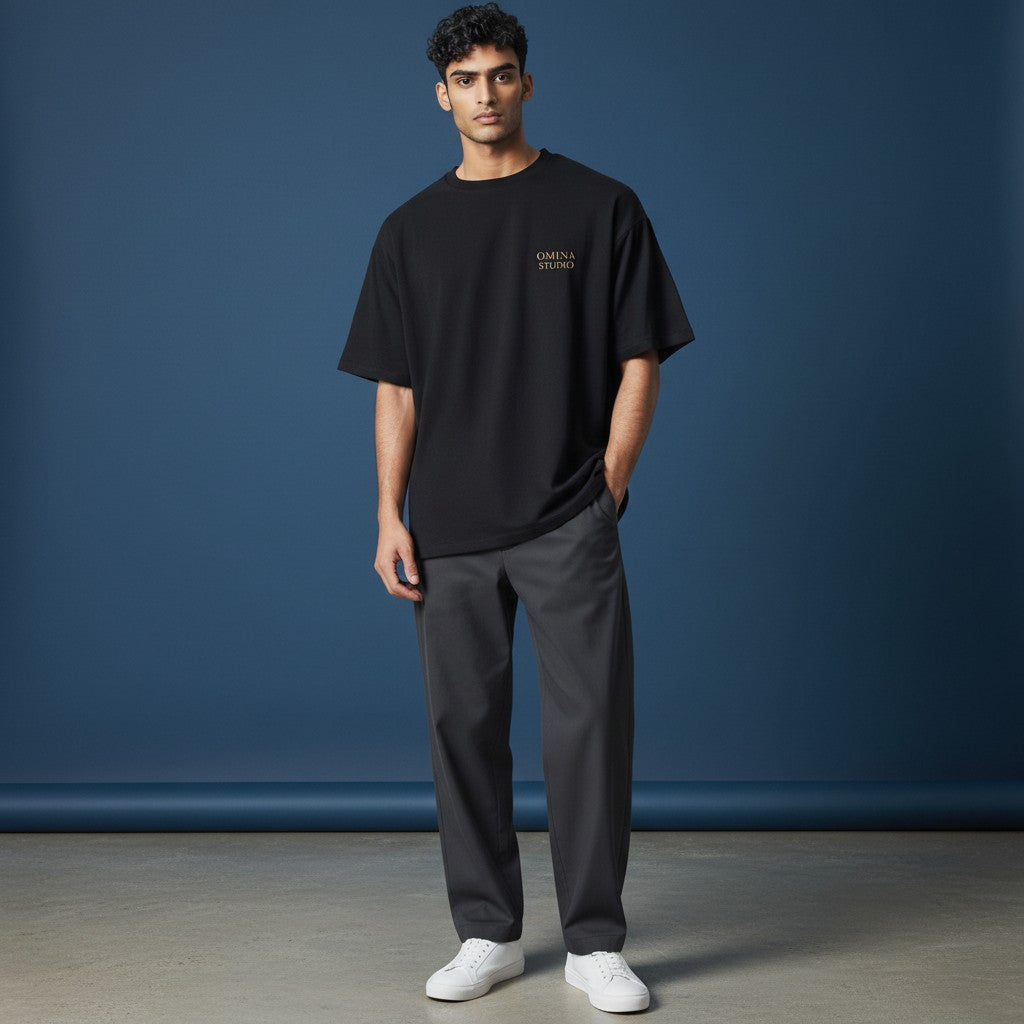 Omina Studio black viscose blend crop t-shirt with round neckline and small gold logo.