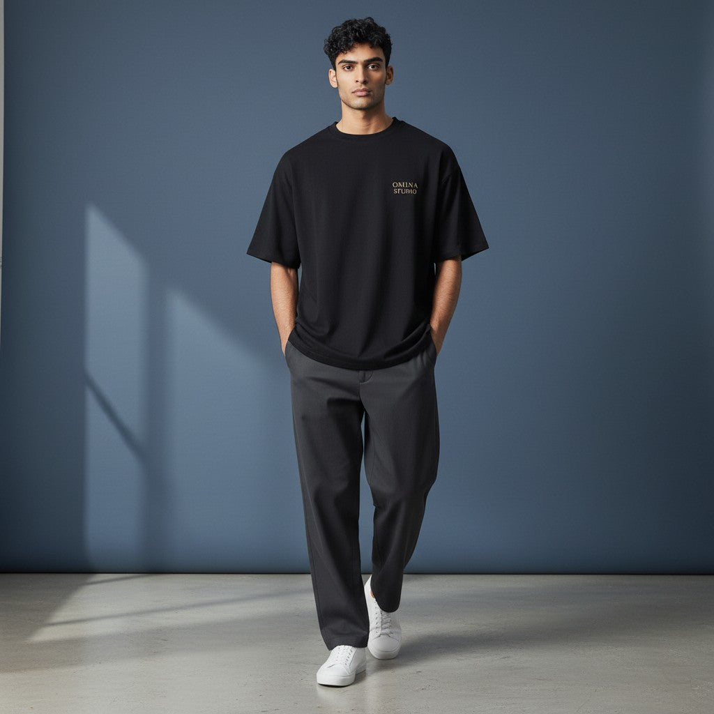 Omina Studio black viscose blend crop t-shirt with round neckline and small gold logo.