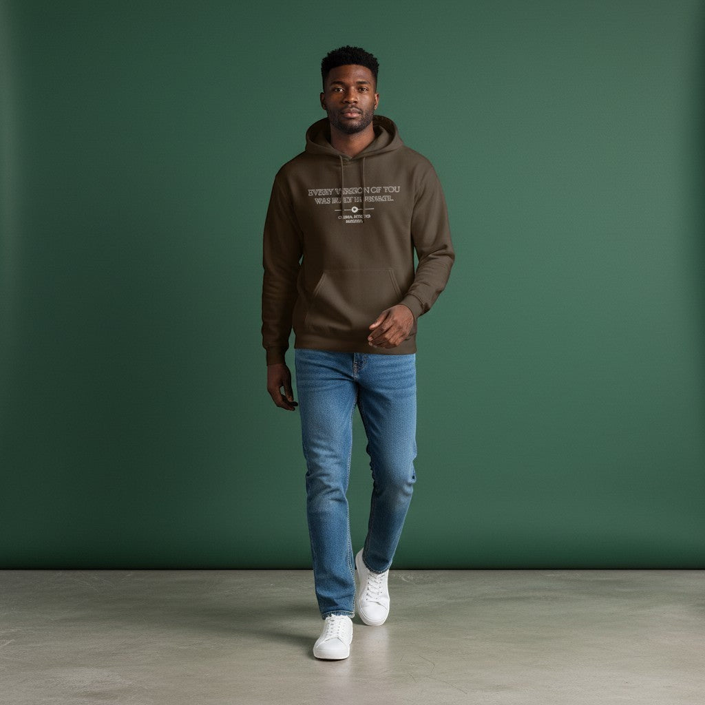 Omina Studio dark brown heavyweight cotton oversized hoodie with "Every Version of You Was Built In Private" graphic.