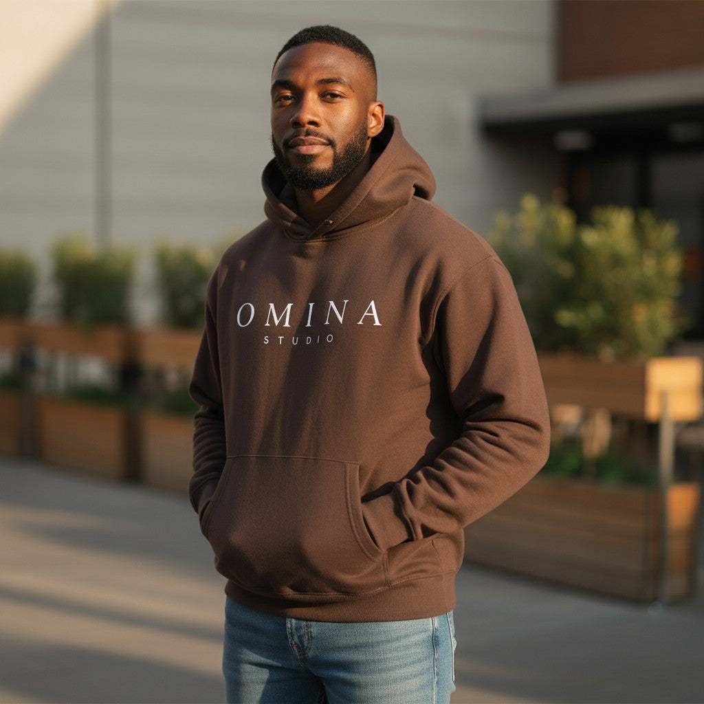 Omina Studio oversized brown fleece hoodie with white logo and front pocket. Crafted from a cotton blend, ideal for casual wear.