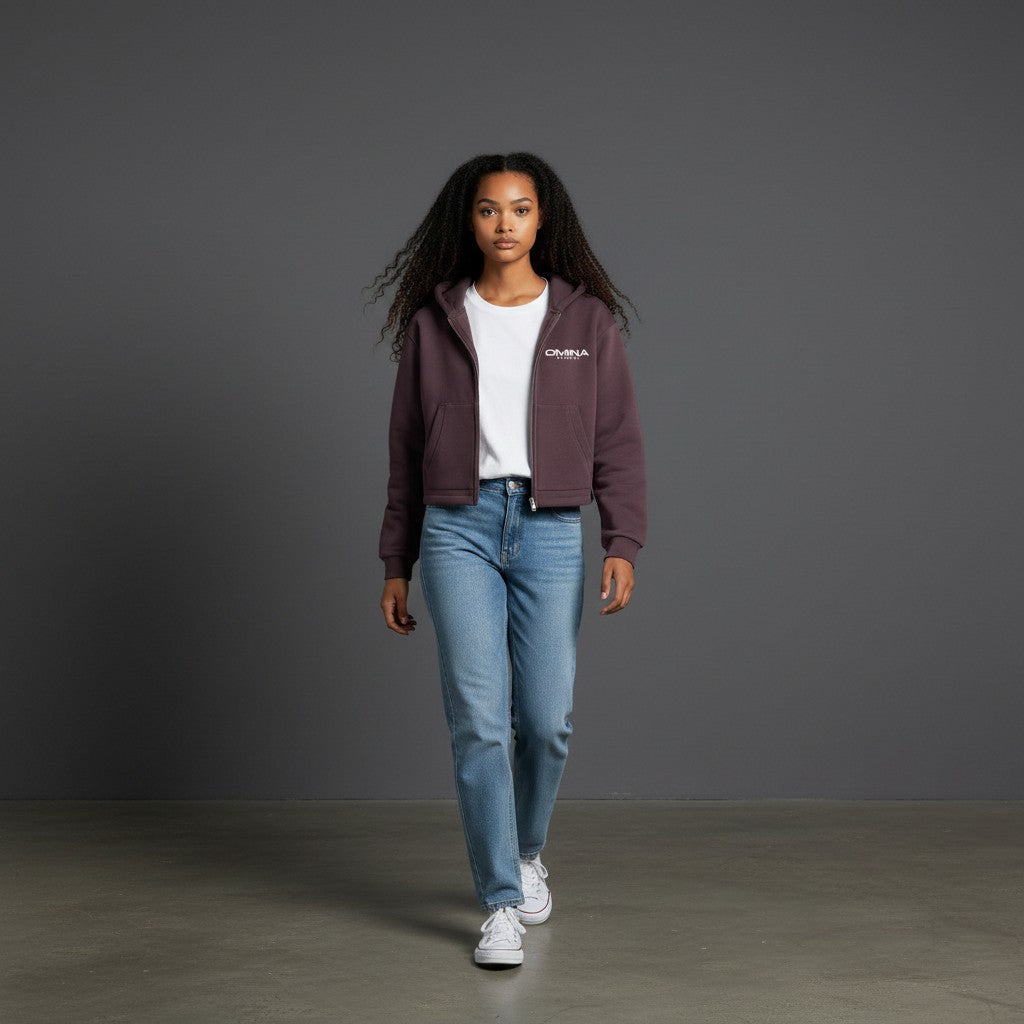 Omina Studio cropped zip hoodie in dark plum, made from a cotton-blend fleece with a relaxed fit and front pockets.
