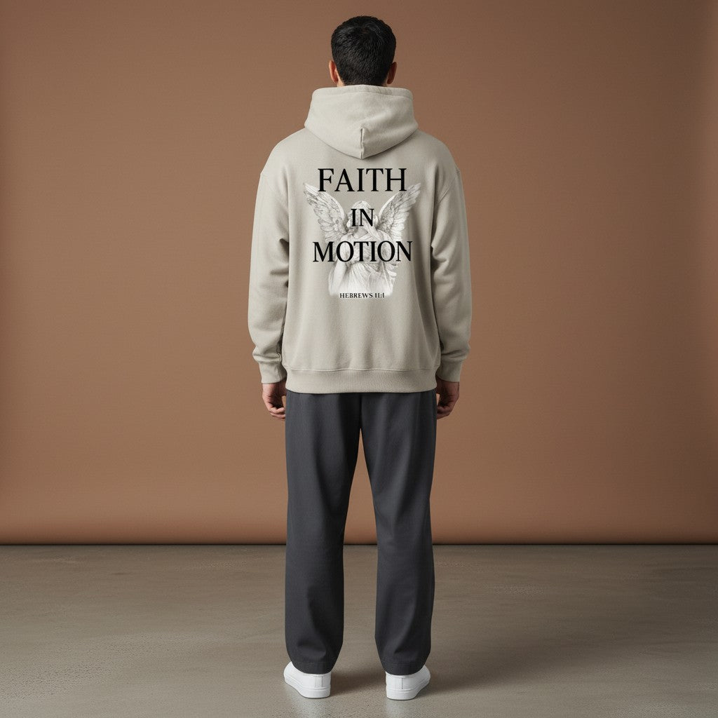 Omina Studio beige heavyweight hoodie with "Faith in Motion" graphic and angel illustration on back.