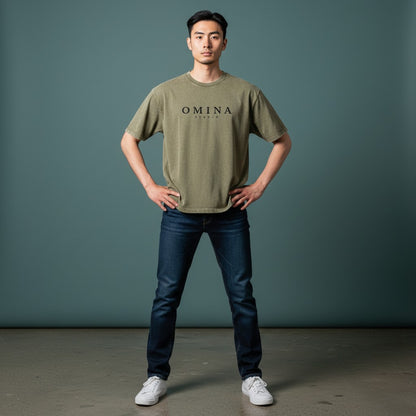 Omina Studio olive green mineral wash cotton t-shirt with black logo graphic on chest.