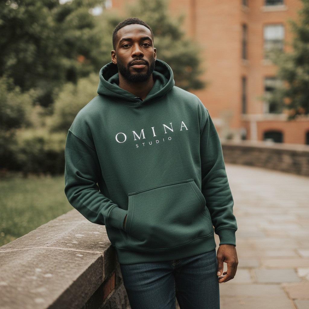 Omina Studio oversized forest green fleece hoodie with white logo and front pocket. Unisex, thick fabric, long sleeves, hooded.