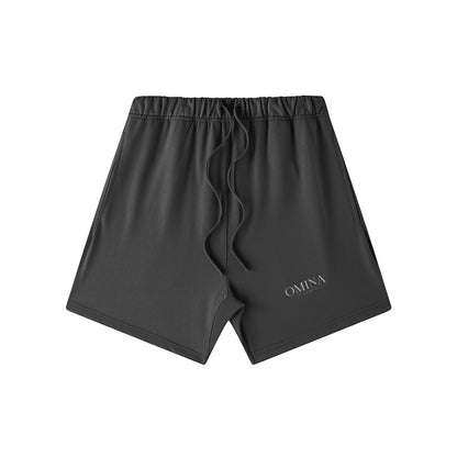 Omina Studio charcoal grey heavyweight French terry shorts with elastic waist, drawstring, and side pockets. Oversized fit.