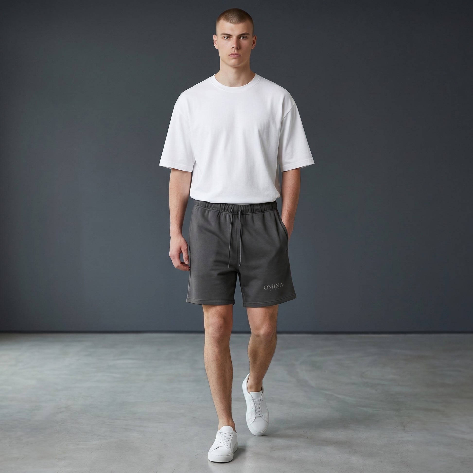 Omina Studio charcoal grey heavyweight French terry shorts with elastic waist, drawstring, and side pockets.