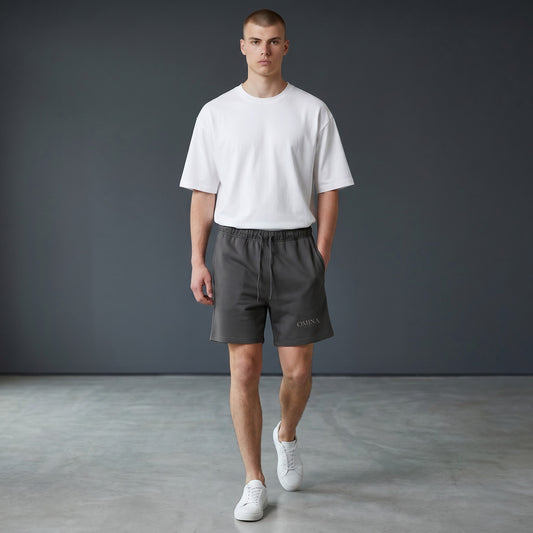 Omina Studio charcoal grey heavyweight French terry shorts with elastic waist, drawstring, and side pockets.