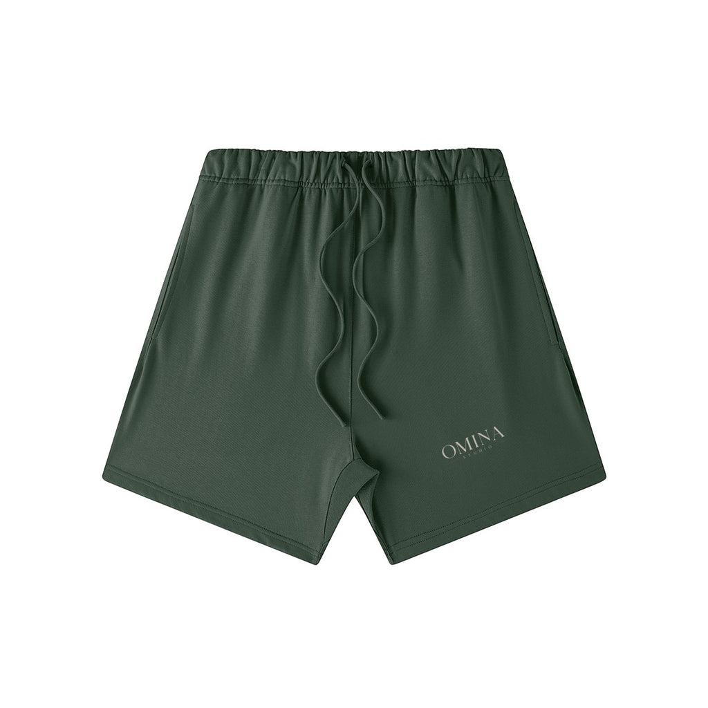 Omina Studio dark green heavyweight French terry shorts with elastic waist, drawstring, and side pockets. Oversized fit.