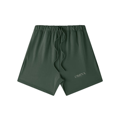 Omina Studio dark green heavyweight French terry shorts with elastic waist, drawstring, and side pockets. Oversized fit.