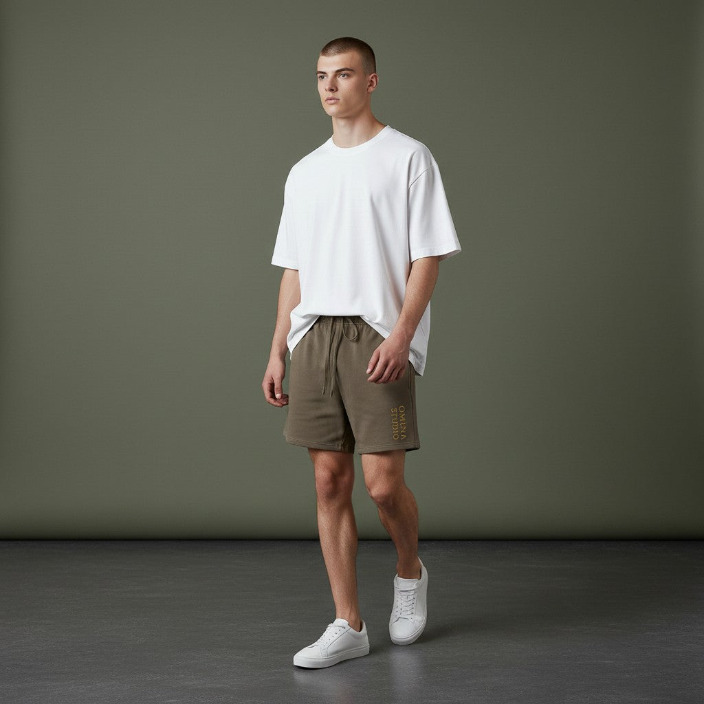 Omina Studio heavyweight olive green cotton French terry shorts with drawstring and side pockets.