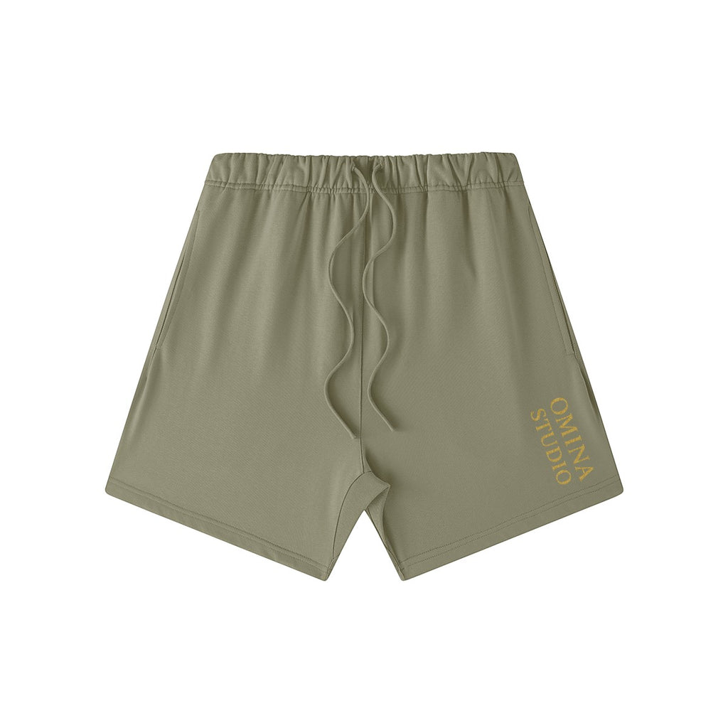 Omina Studio olive green heavyweight cotton French terry shorts with drawstring and logo.