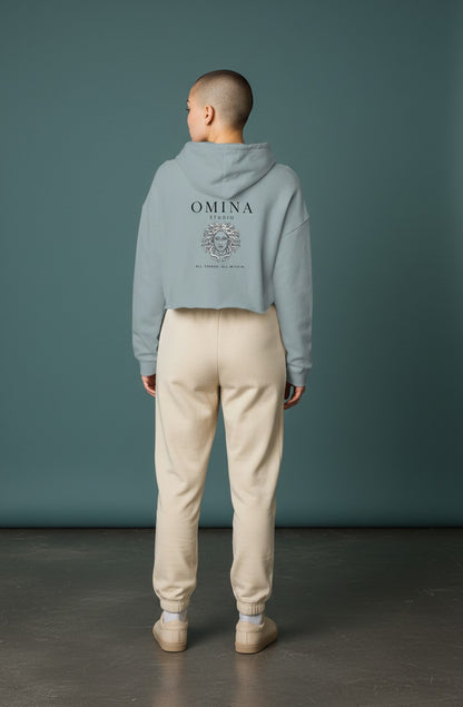 Omina Studio light blue lightweight cropped hoodie with adjustable drawstring hood and raw hem. Features graphic.