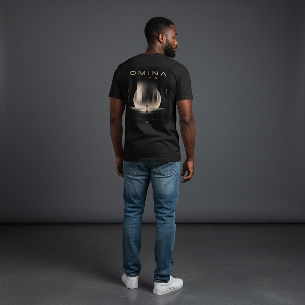 Omina Studio black heavyweight cotton t-shirt with a large graphic featuring a silhouette of a person standing before a large moon-like orb with abstract pillars.