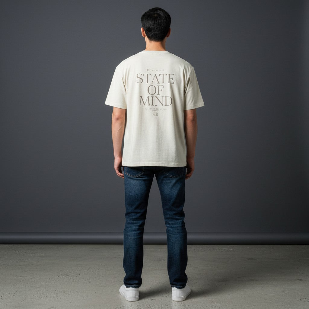 Omina Studio cream cotton blend t-shirt with "STATE OF MIND" graphic print on back. Short sleeve, crew neck.