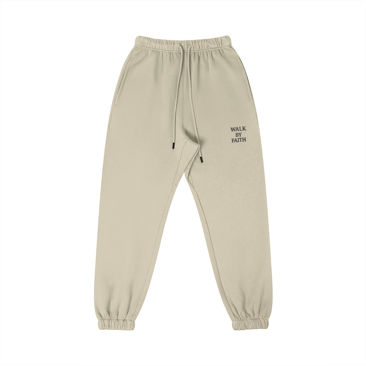Omina Studio beige cotton sweatpants with "Walk By Faith" embroidered on the left thigh. Features elastic waistband, drawstring, and tapered legs.