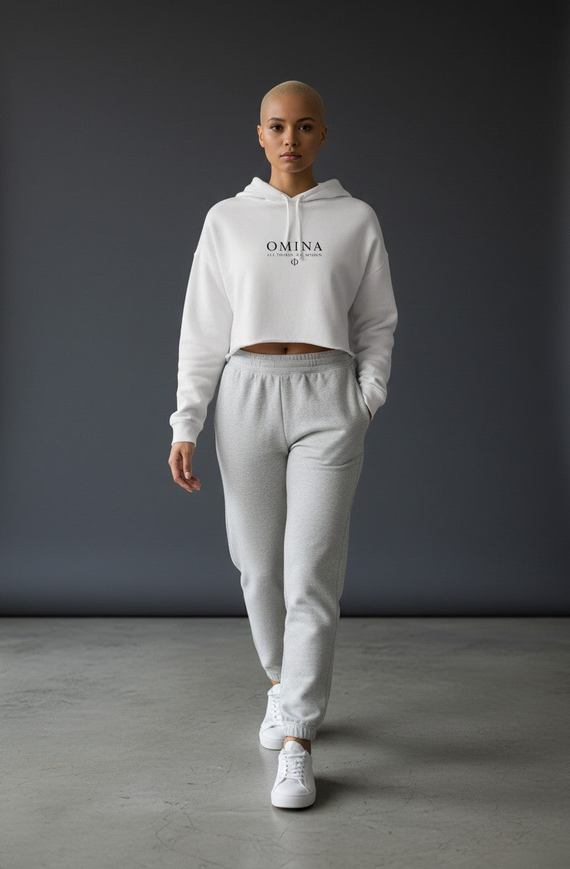 Omina Studio white lightweight cropped hoodie with adjustable drawstring hood and raw hem. Features OMINA logo.