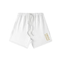 Omina Studio white heavyweight cotton French terry shorts with drawstring and gold logo detail.