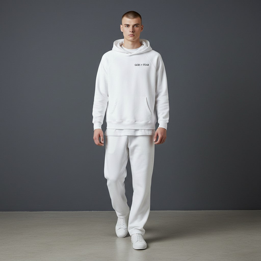 Omina Studio white pullover hoodie with "GOD > FEAR" graphic, kangaroo pocket, and raglan sleeves.
