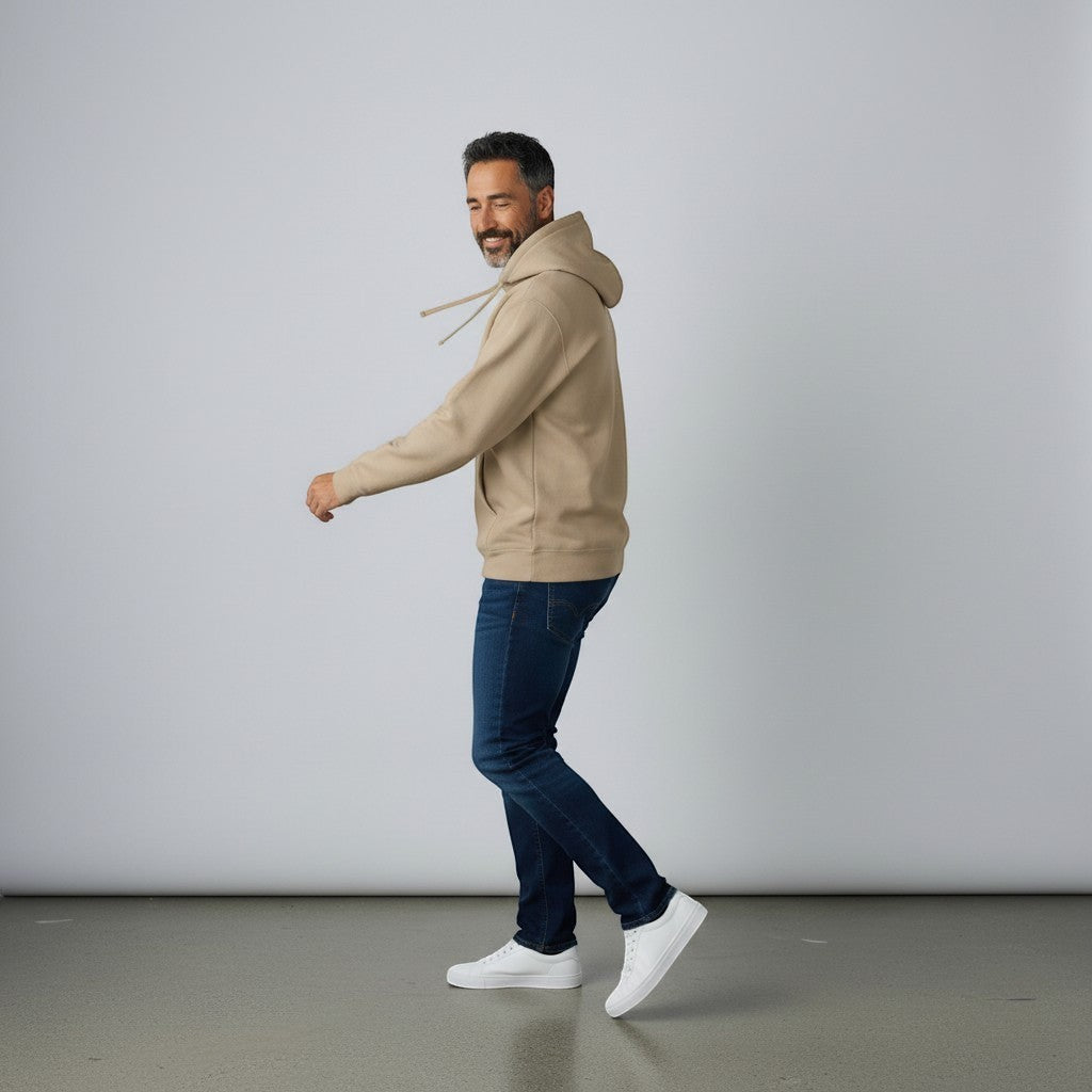 Omina tan pigment-dyed cotton blend hoodie with relaxed fit, jersey-lined hood, and front pouch pocket worn by a man.