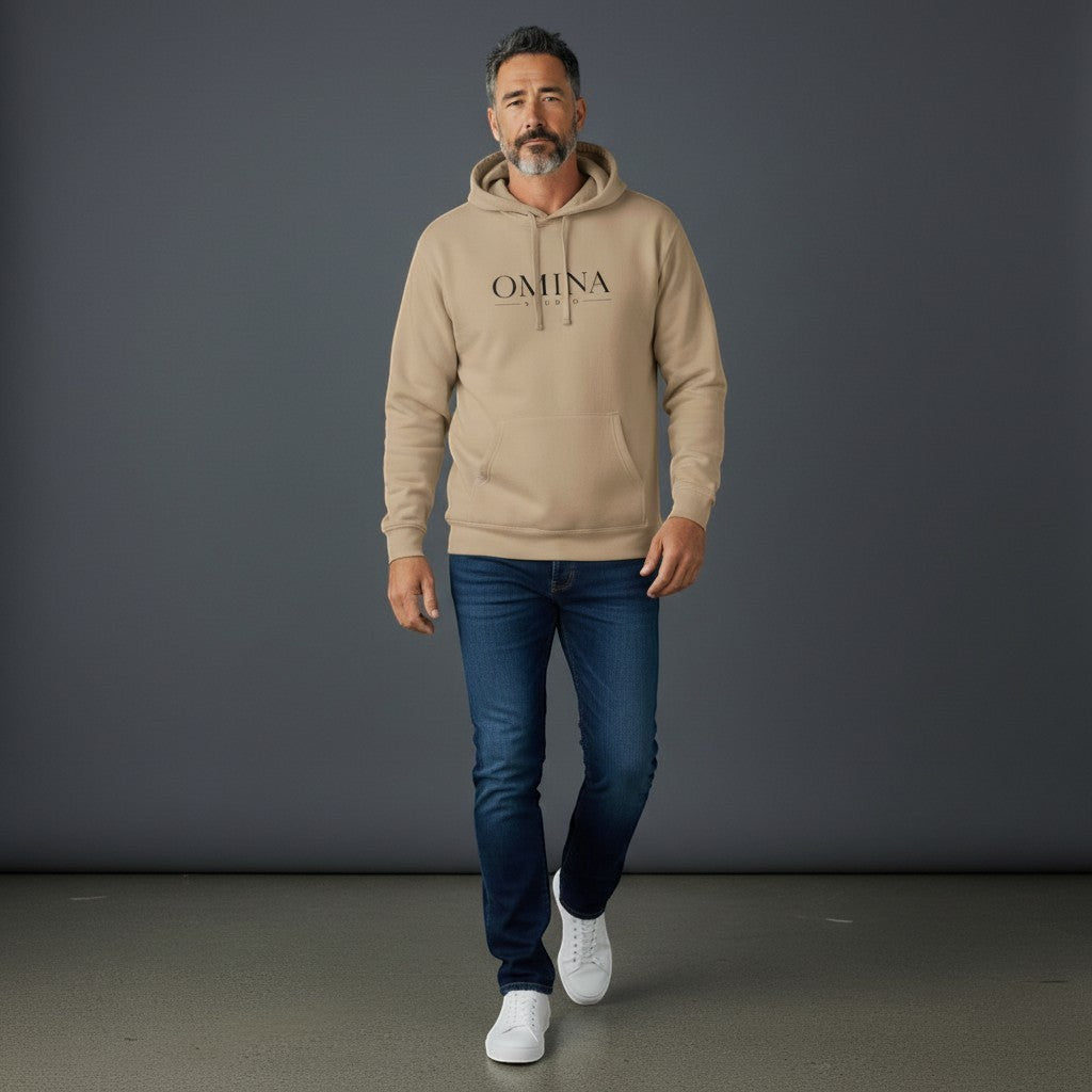 Omina Studio tan pigment-dyed cotton blend hoodie with front logo and relaxed fit, worn by a man.