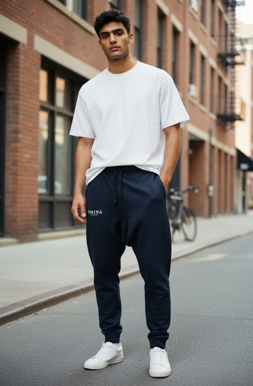 Omina Studio navy blue unisex premium joggers with drawstring waist and subtle logo detail.