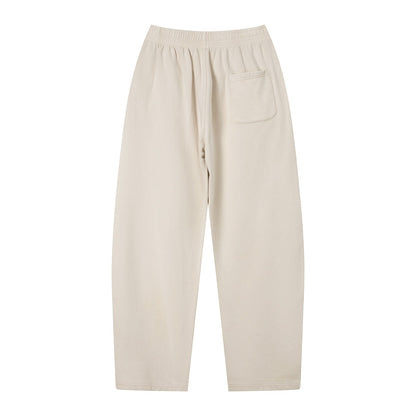Omina Studio unisex vintage wash loose sweatpants in light beige, made from a soft heavyweight cotton blend with a single back pocket.