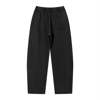 Omina Studio black vintage wash loose fit sweatpants with elastic waistband and single back pocket. Soft heavyweight cotton blend.