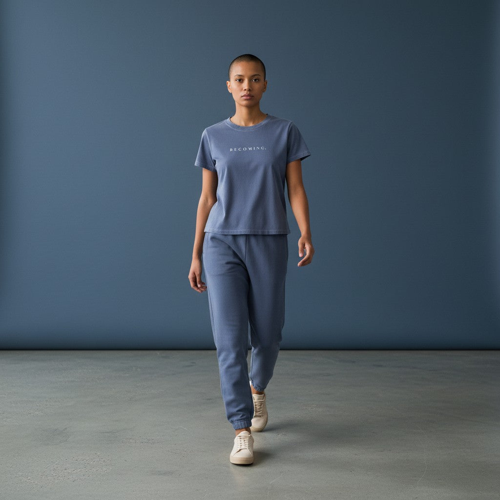 OMINA Essentials dusty blue cotton t-shirt with 'BECOMING.' text in white, vintage wash, slim fit.
