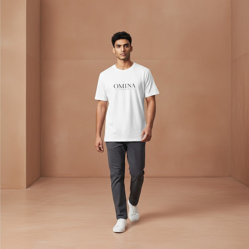 OMINA Studio white cotton t-shirt with minimalist front logo and bold back graphic. Model wears relaxed fit tee.