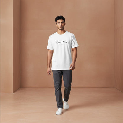 OMINA Studio white cotton t-shirt with minimalist front logo and bold back graphic. Model wears relaxed fit tee.