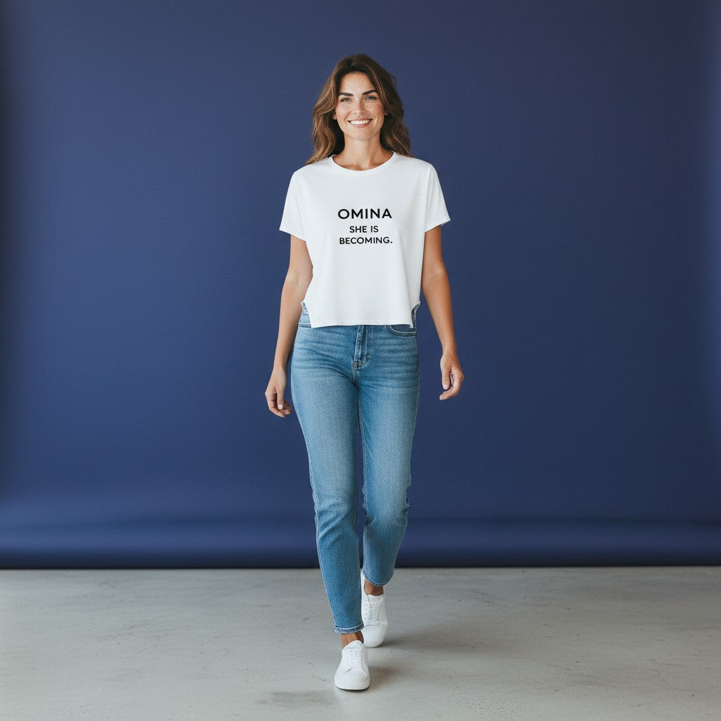 Omina white cropped dolman t-shirt with black text "SHE IS BECOMING."