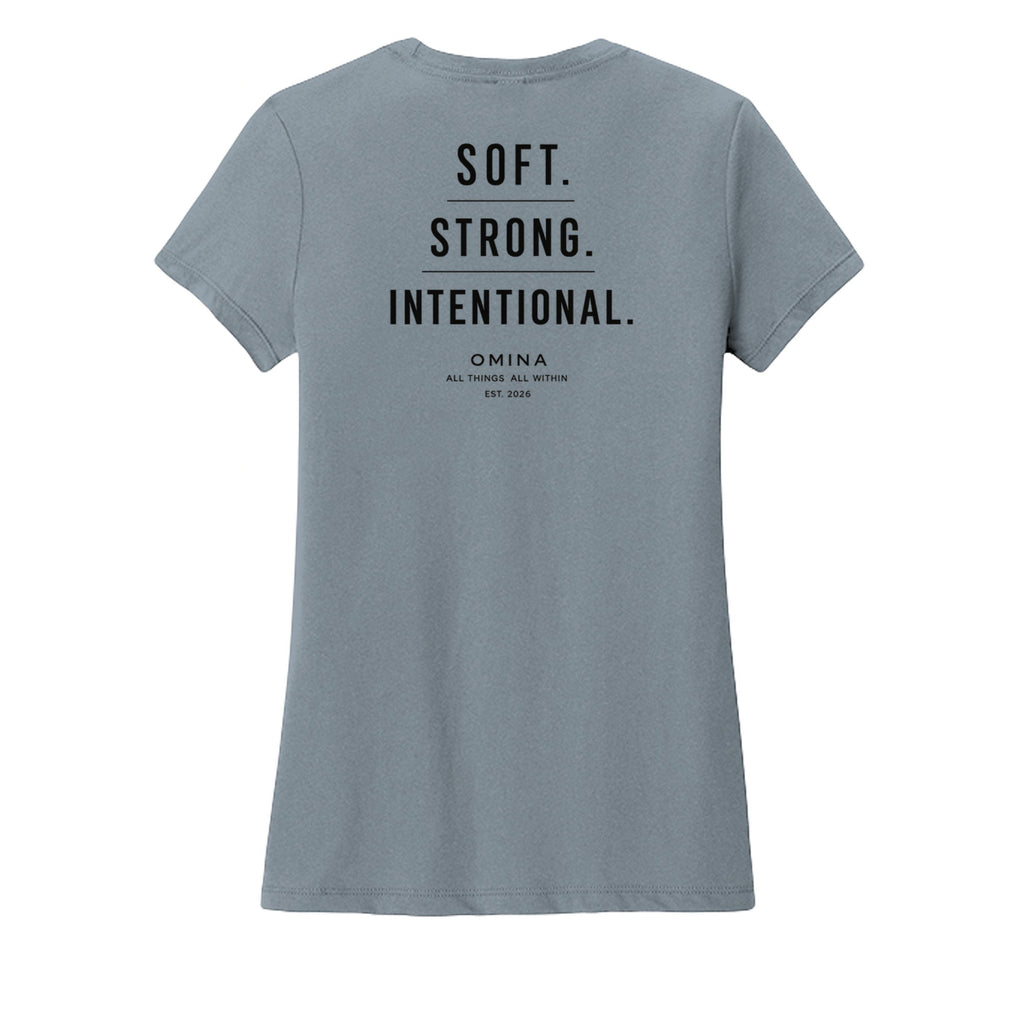 Omina women's soft grey t-shirt with black text reading SOFT. STRONG. INTENTIONAL. OMINA ALL THINGS ALL WITHIN EST. 2026.