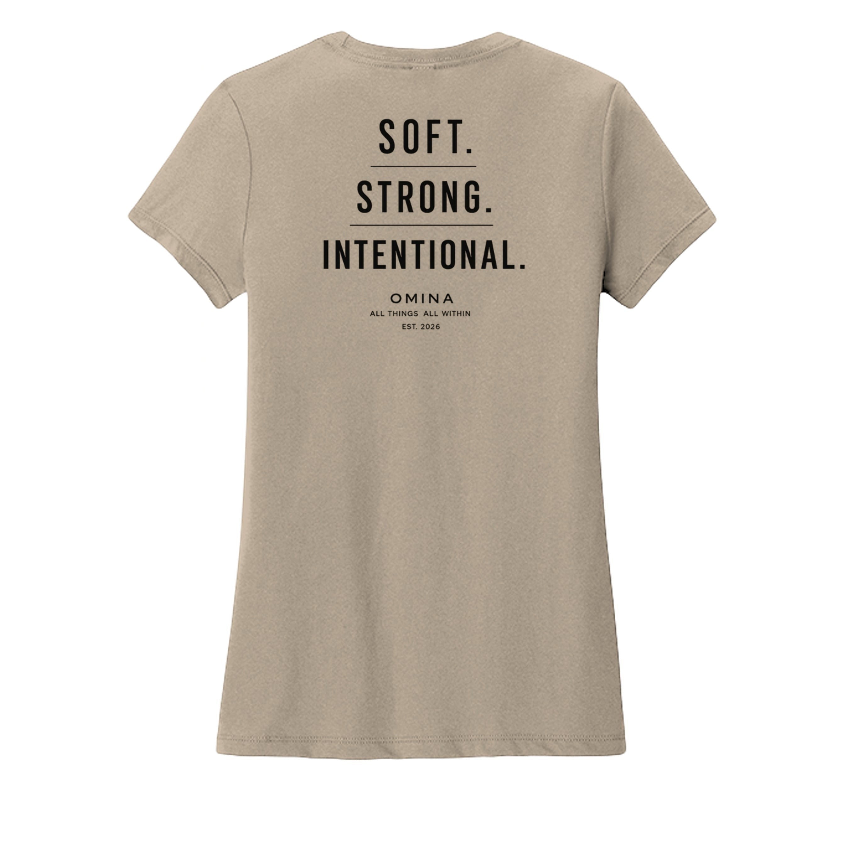 Omina women's tan crew neck t-shirt with black text reading SOFT. STRONG. INTENTIONAL. OMINA ALL THINGS ALL WITHIN EST. 2026