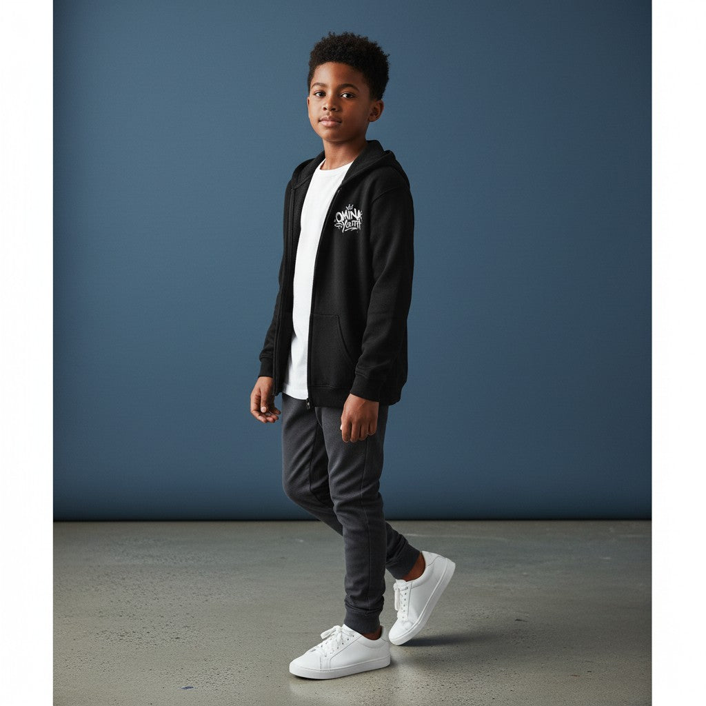 Omina Youth black zip-up hoodie with white graffiti-style logo on chest. Relaxed fit, soft interior, streetwear silhouette.