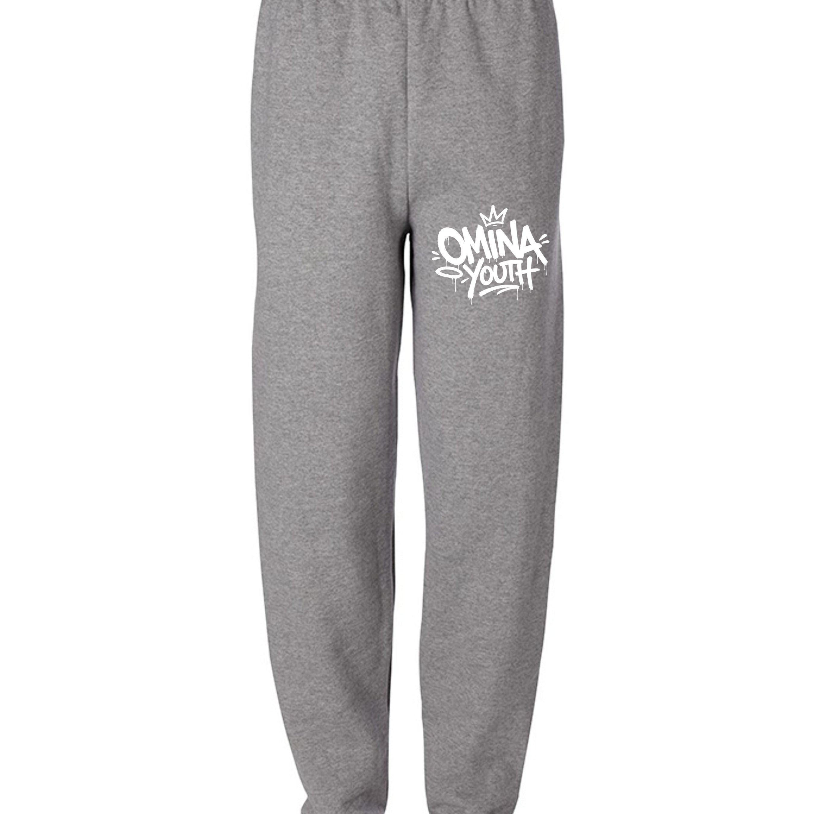 Omina Youth grey sweatpants with relaxed fit and white graffiti-style logo on left thigh.