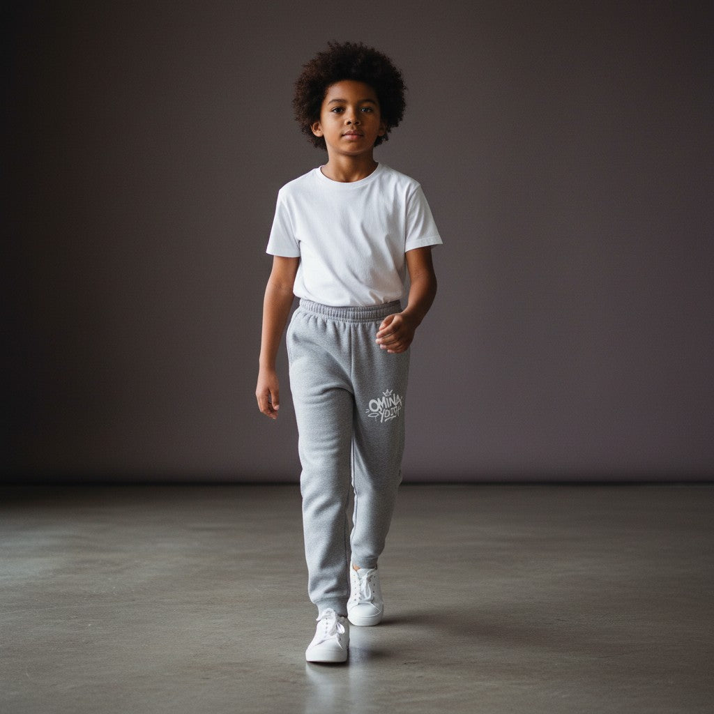 Omina Youth grey sweatpants with relaxed fit and white logo graphic on left thigh. Made from soft premium fabric.