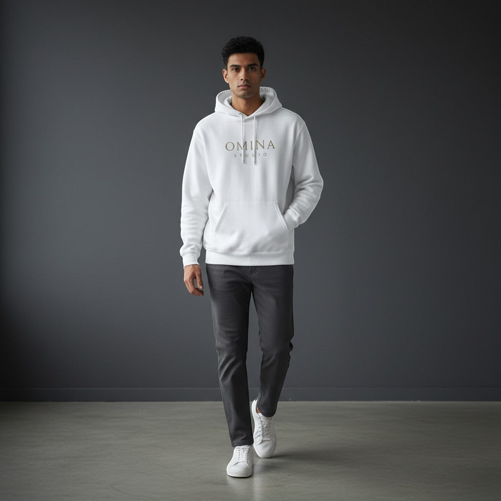 Omina Studio white essential hoodie with minimalist logo and kangaroo pocket, worn by a man.